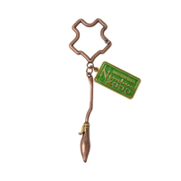 Bronze Nimbus 2000 keychain with a green tag on a white background