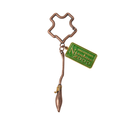 Bronze Nimbus 2000 keychain with a green tag on a white background