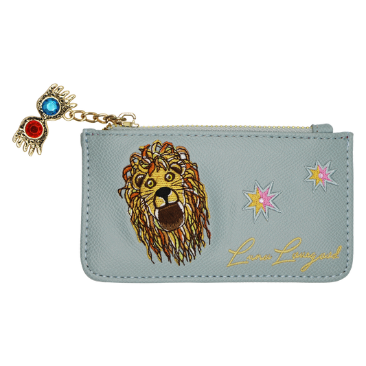 A light blue faux leather zippered pouch featuring a large embroidered lion face, two star motifs, gold cursive 'Luna Lovegood' script, and a dangling Spectrespecs charm with red and blue stones on a gold chain.