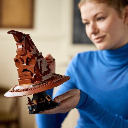 Person holding a detailed model of the Sorting Hat made from building blocks.